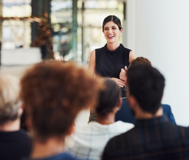 woman laighing and talking to a group of people